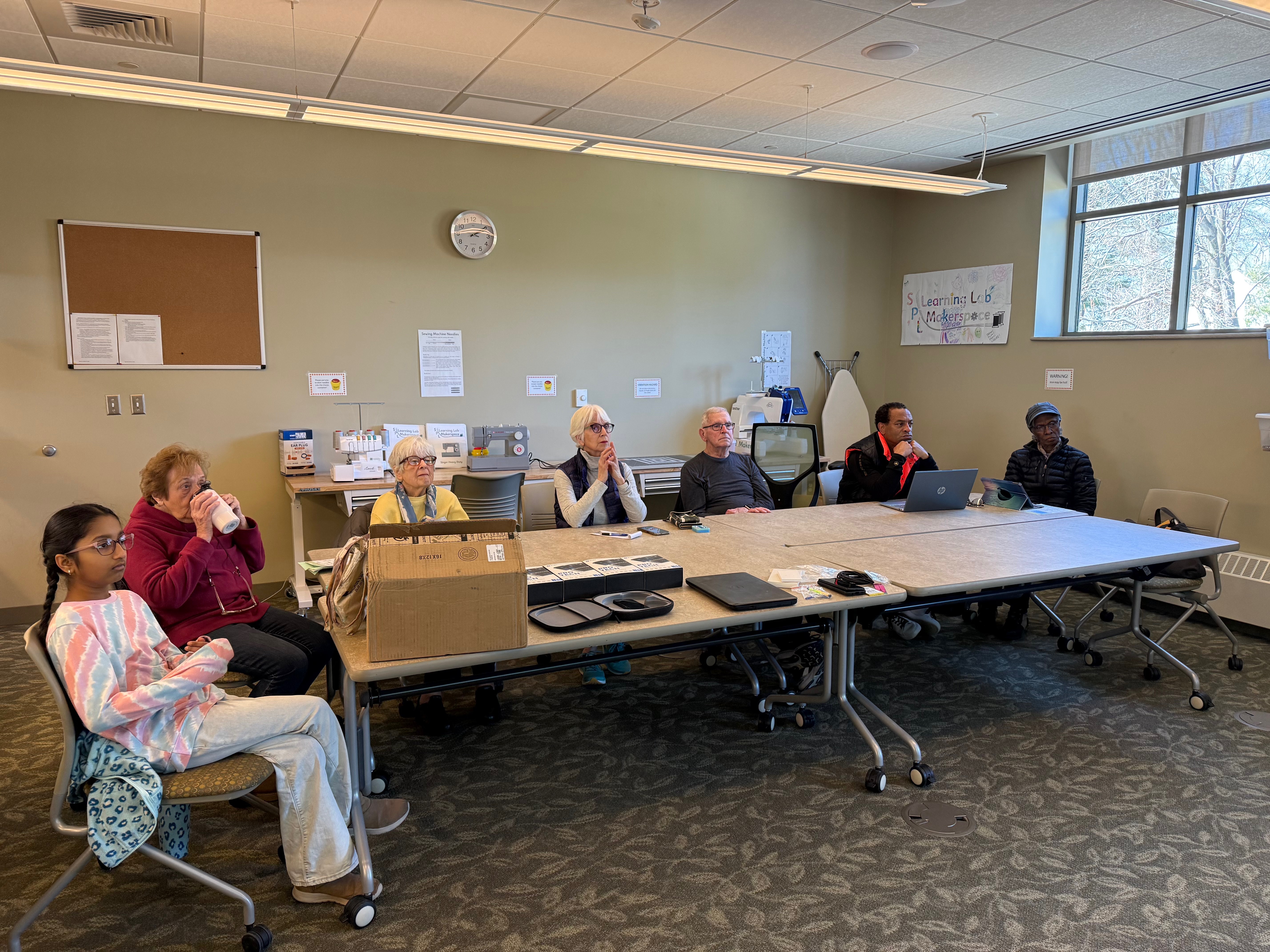 Students collaborating during a device repair training session