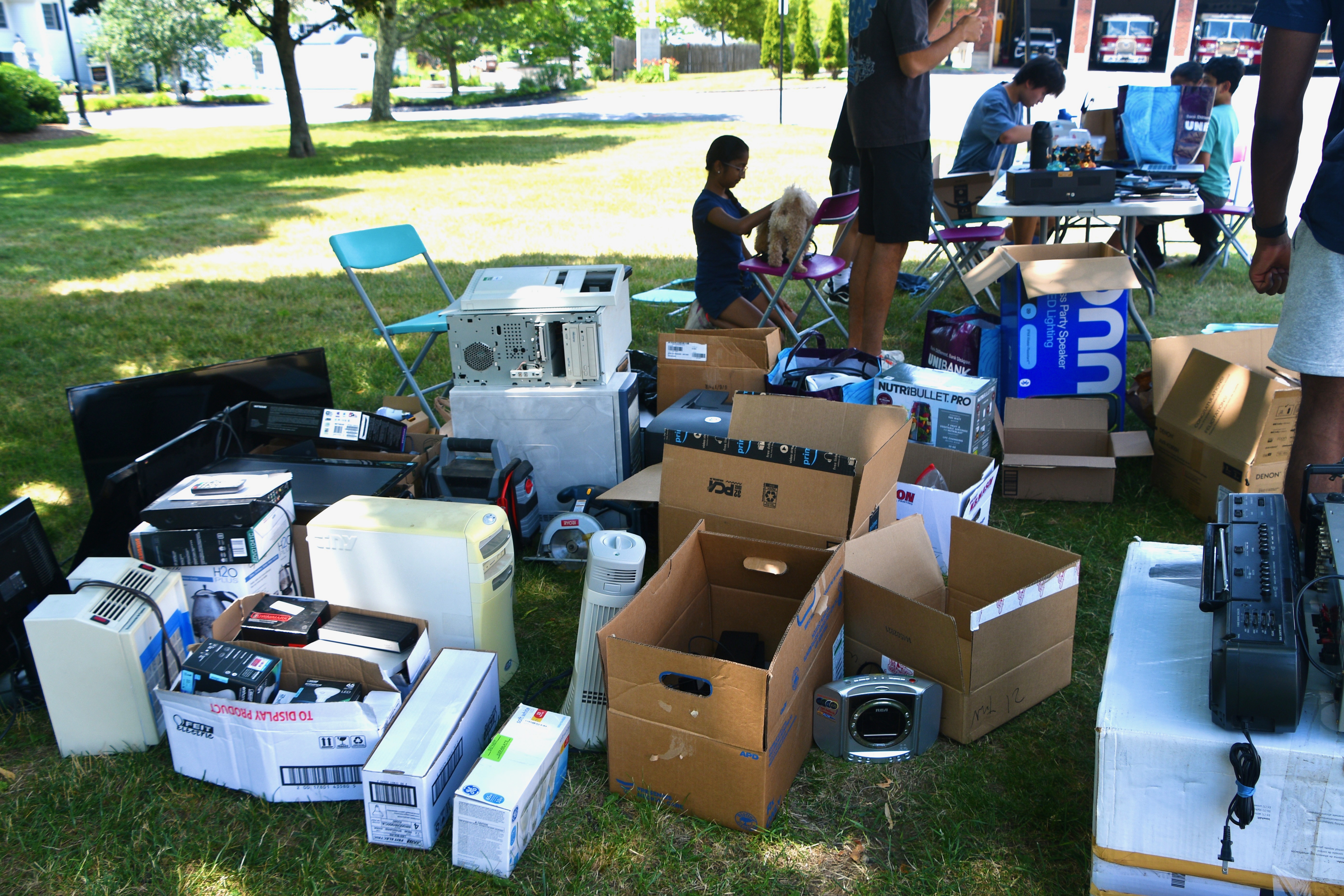 Boxes of donated electronics at an outdoor e-waste drive