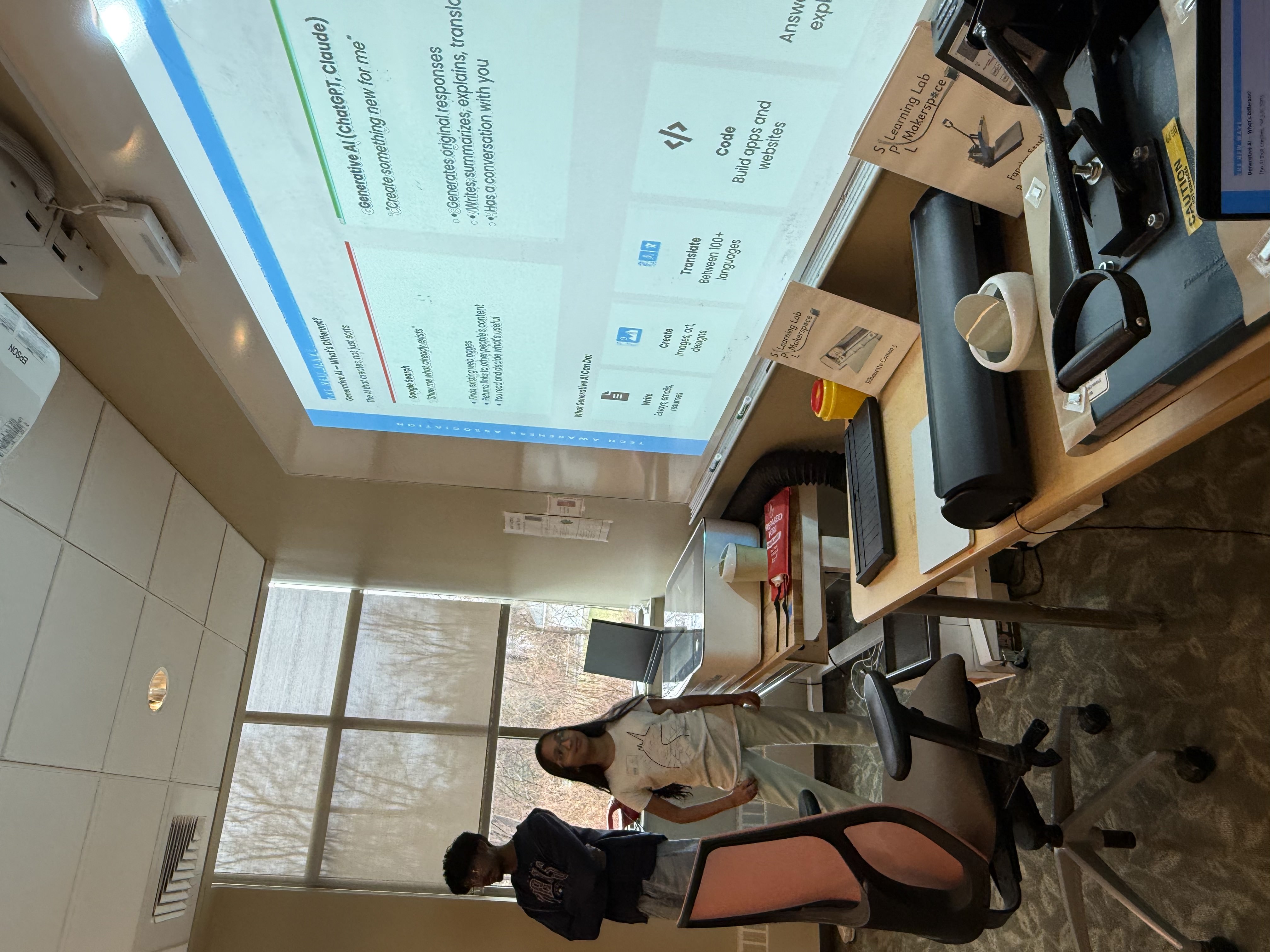 Volunteers presenting a digital literacy slide about generative AI