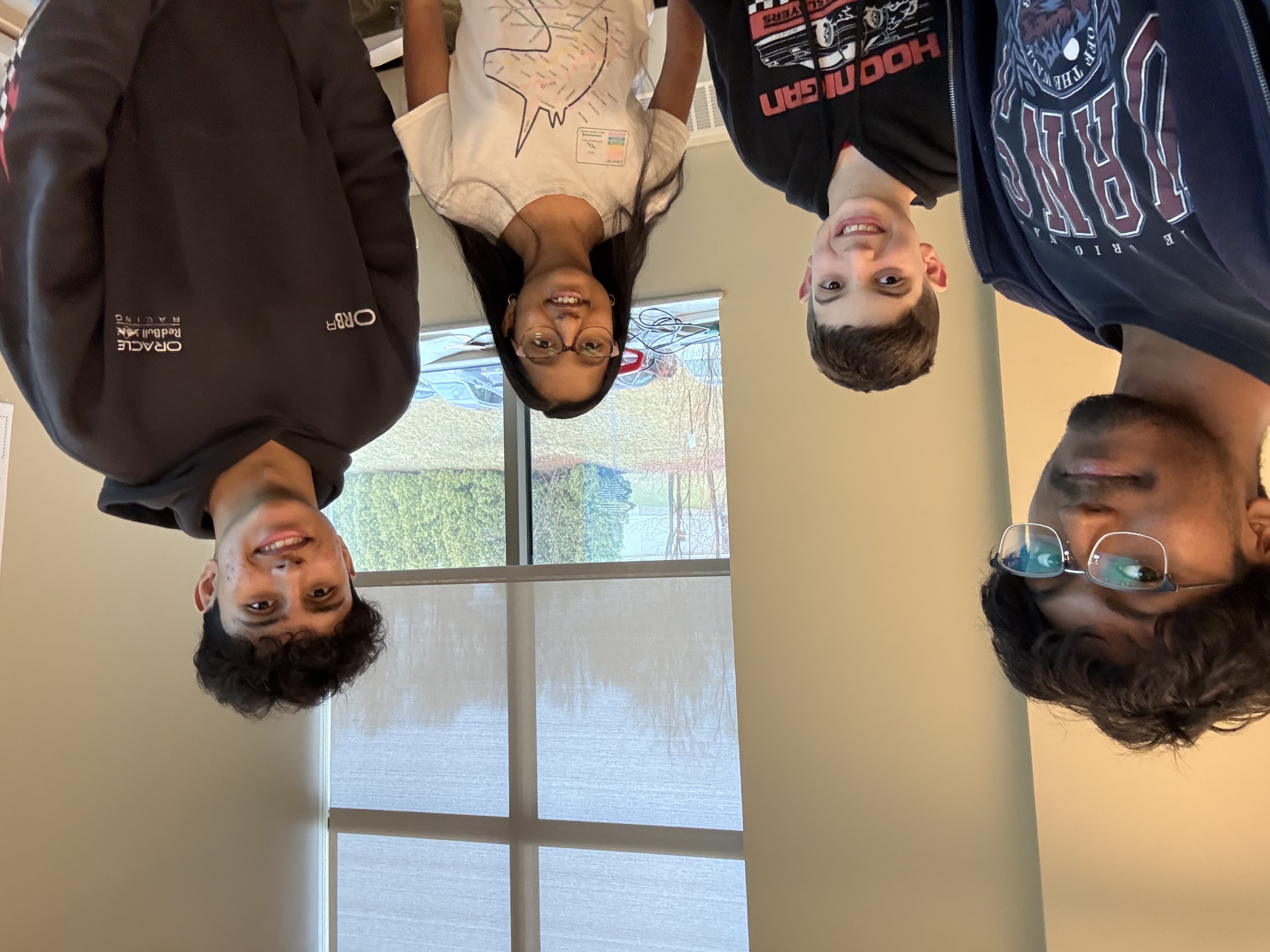 Four TAA team members smiling together at a workshop